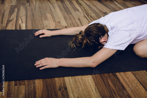Young woman practicing yoga in home.