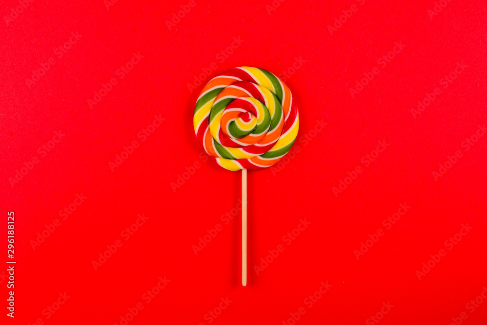 Colorful candy on a red background. Lollipop. Top view. Copy space. Colorful candy on a red background. Lollipop. Top view. Copy space.
