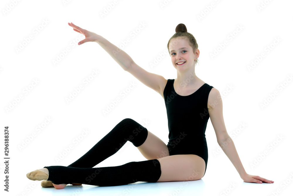 Girl gymnast in black leggings, sport concept. Girl gymnast in black leggings, sport concept.