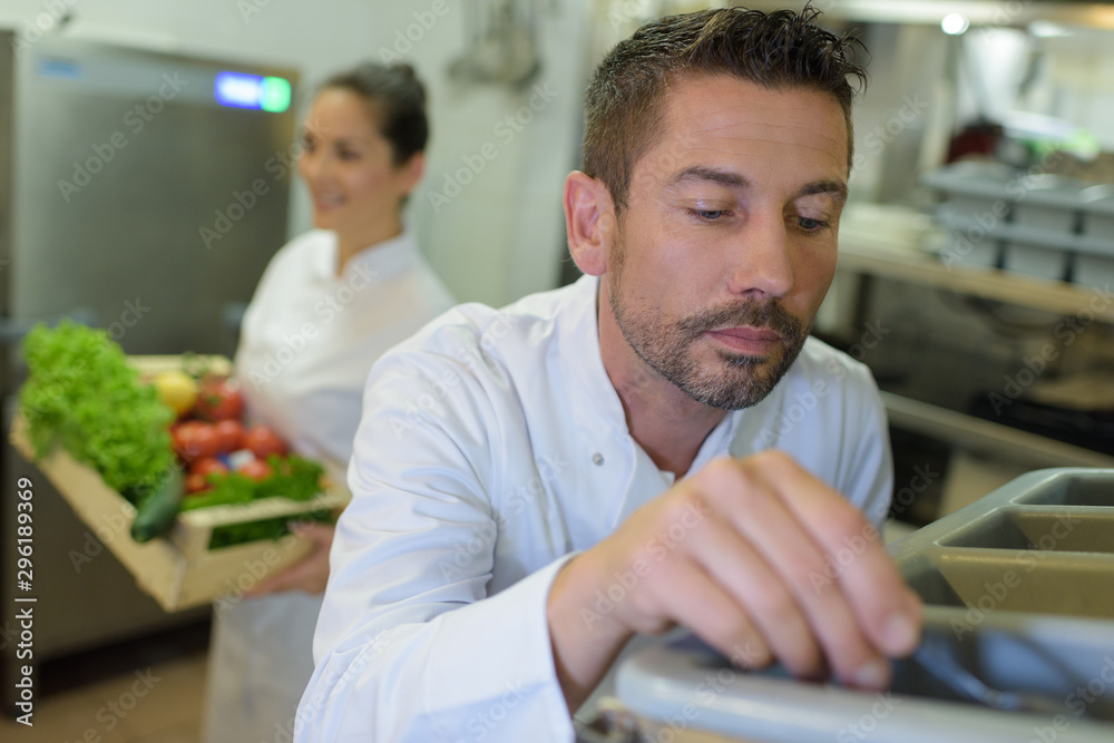 restaurant pantry worker taking cutlery out restaurant pantry worker taking cutlery out