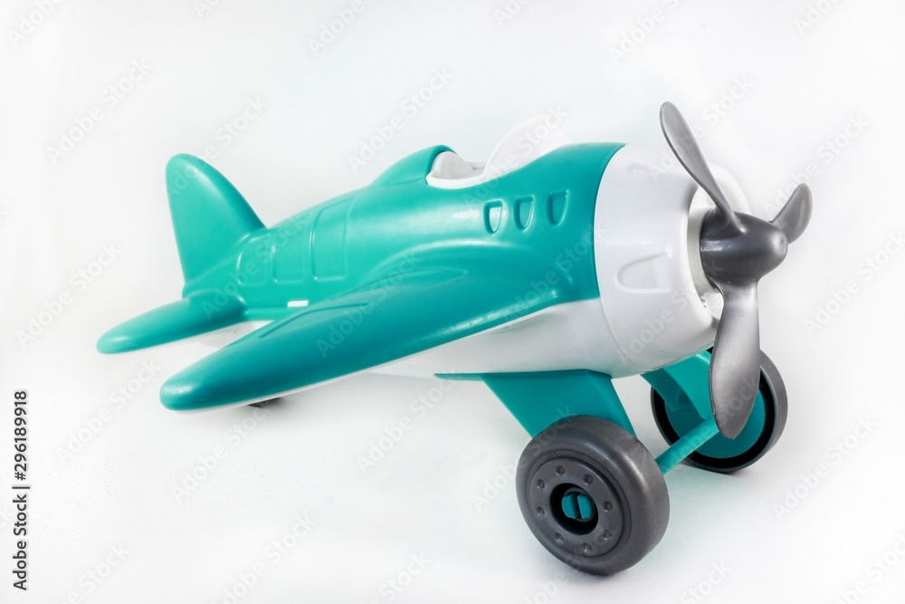 toy, plastic airplane with a propeller, without a pilot on a white background, turquoise brush, side view
