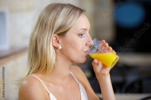 a woman drinking orange juice
