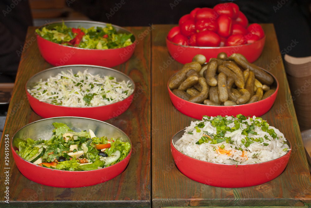 Lots of sliced vegetables on the table. Demonstration of kitchen appliances for shredding fruits. Useful food at the festival. Lots of sliced vegetables on the table. Demonstration of kitchen appliances for shredding fruits. Useful food at the festival.