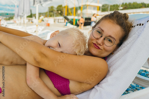 Mothers Day. Mom and son are on vacation together lying on a deck chair. family vacation at sea