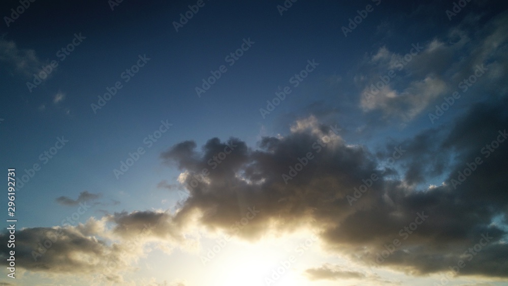 Fototapeta premium sunset stroking the clouds the sky the earth and the sea