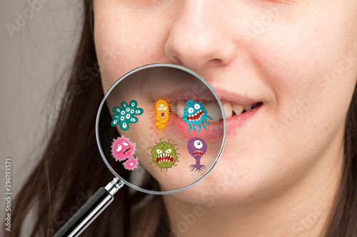 Photography Magnifying glass showing possible microbes of the oral cavity responsible for ca