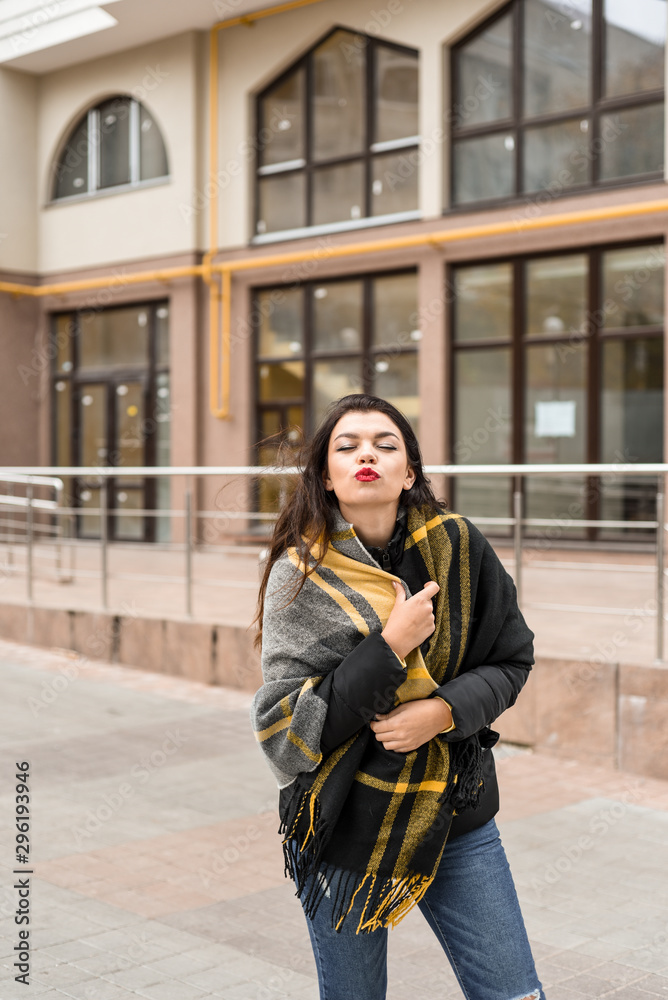 girl with a yellow scarf walks the city
