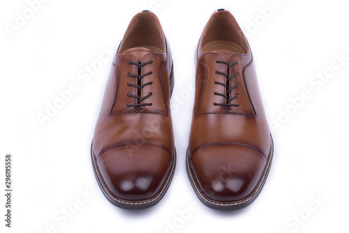 Clean, classic leather elegant shoe on a white background. Beautiful brown luxury and casual leather men shoes. Fashion accessory. Top, front view.Both legs on the ground. Isolated. 