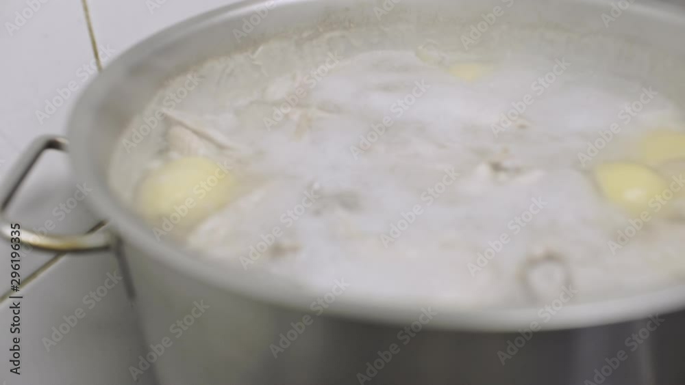 Close up of chicken stock boiled in a big pot Close up of chicken stock boiled in a big pot