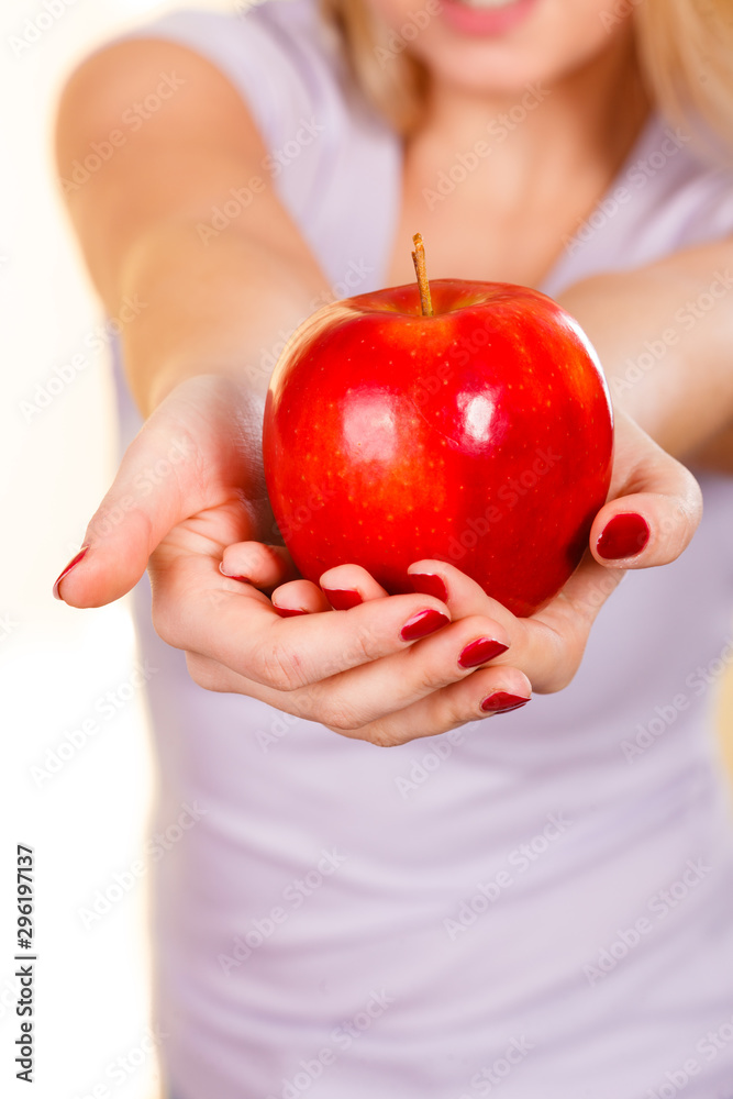 Woman hand holding delicious red apple Woman hand holding delicious red apple