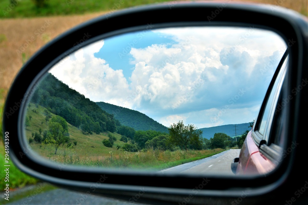 landscape seen through the rearview mirror