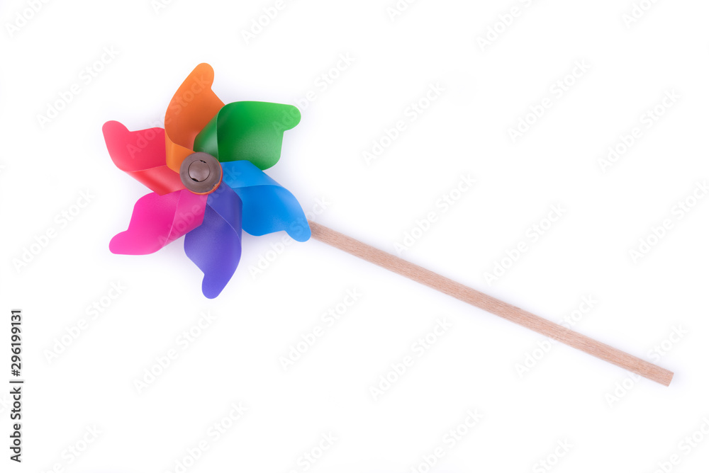 Red, yellow, green and colored windmill toy on white background, isolate. Place for text. Copy space. Red, yellow, green and colored windmill toy on white background, isolate. Place for text. Copy space.