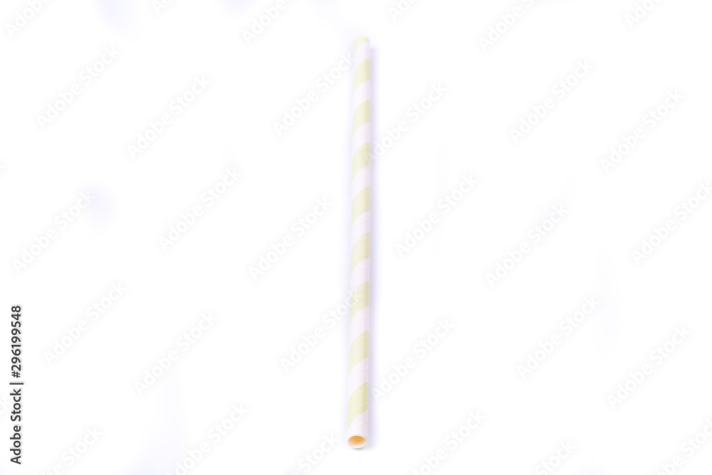 Closeup of drinking straw for party. White with yellow spiral. Top view of colorful disposable eco-friendly straw for summer cocktails. Paper coctail colorful straw on white background, isolated. Closeup of drinking straw for party. White with yellow spiral. Top view of colorful disposable eco-friendly straw for summer cocktails. Paper coctail colorful straw on white background, isolated.