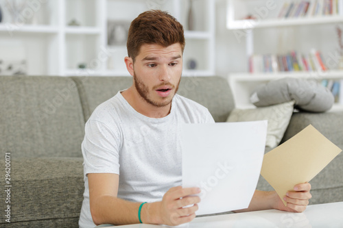 Canvastavla surprised man looking at paper