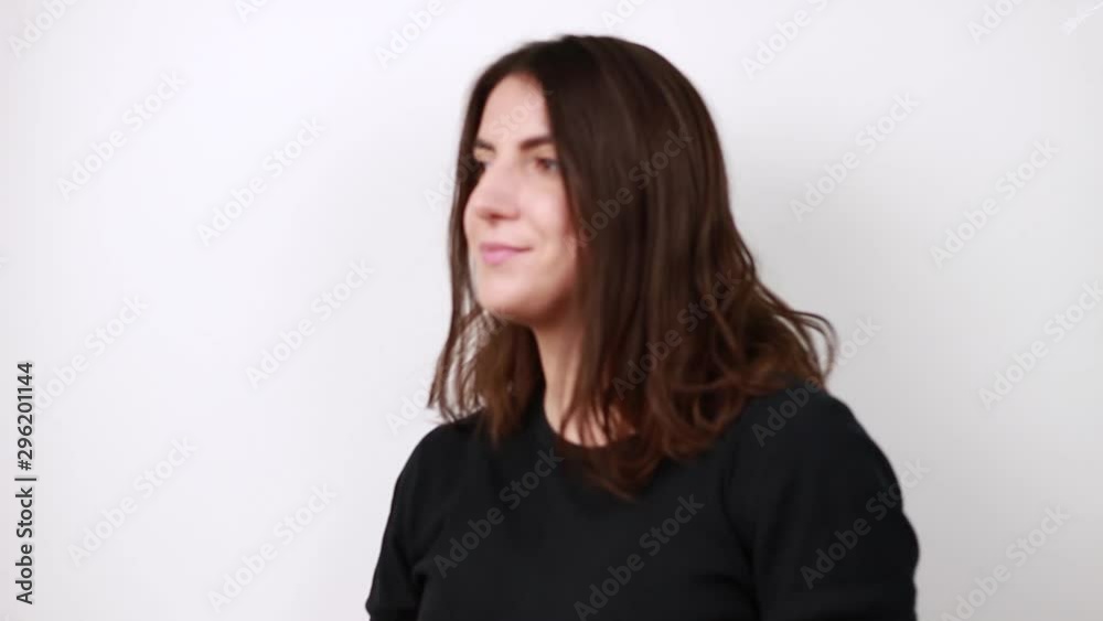 Brown-haired woman loose hair. Shakes her hair. White background Brown-haired woman loose hair. Shakes her hair. White background