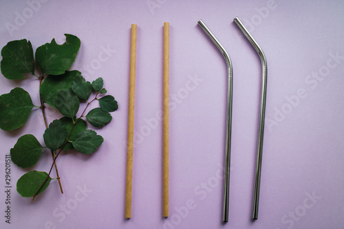 Eco straws made of bamboo and stainless steel on pink background. Sustainable products. photo