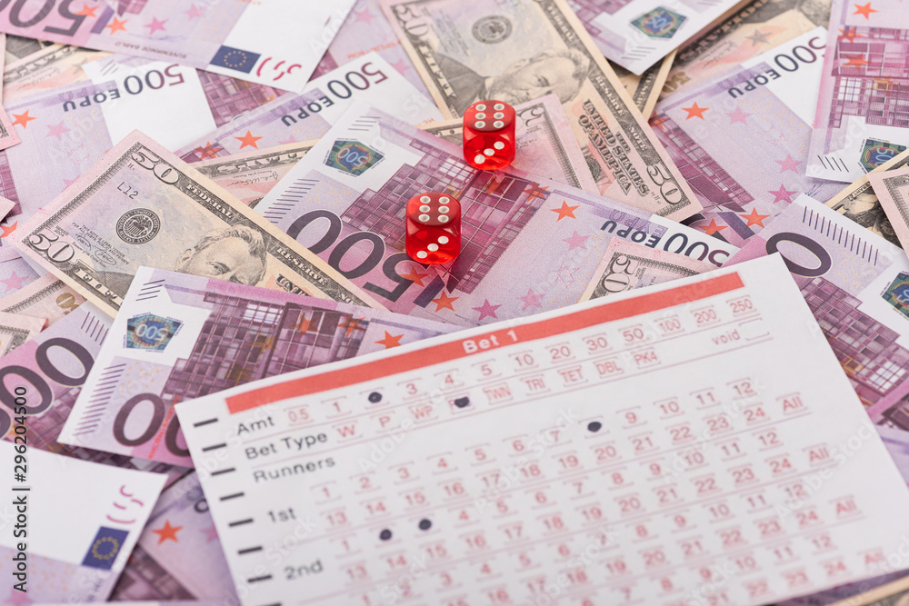 dice and betting list on euro and dollar banknotes, sports betting concept dice and betting list on euro and dollar banknotes, sports betting concept