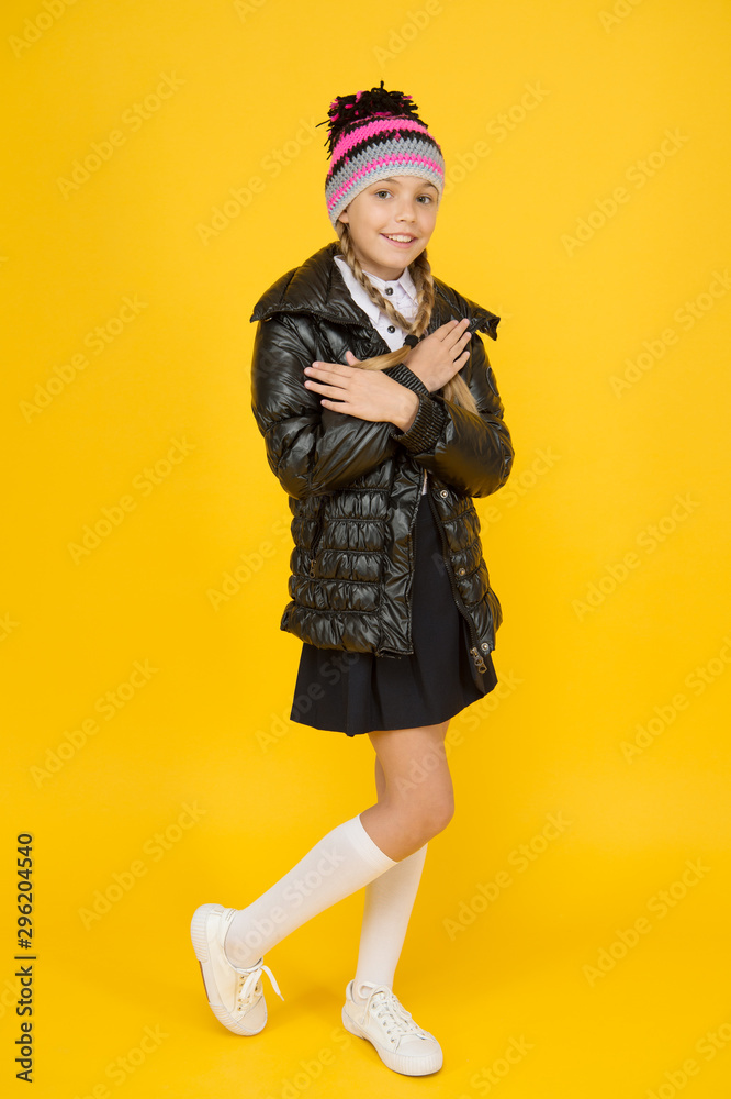 See her through autumn in style. Happy small girl enjoy comfortable fashion style. Little cute child with long blond hair style smile on yellow background. Keep her in style on autumn days See her through autumn in style. Happy small girl enjoy comfortable fashion style. Little cute child with long blond hair style smile on yellow background. Keep her in style on autumn days