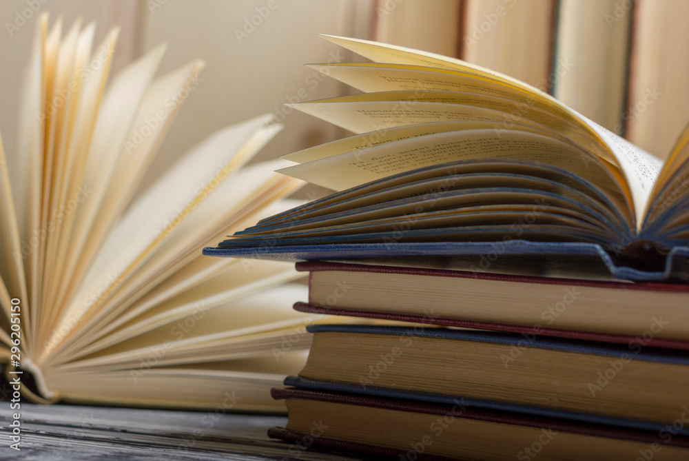 Fototapeta premium Open book, hardback books on wooden table. Back to school. Copy space