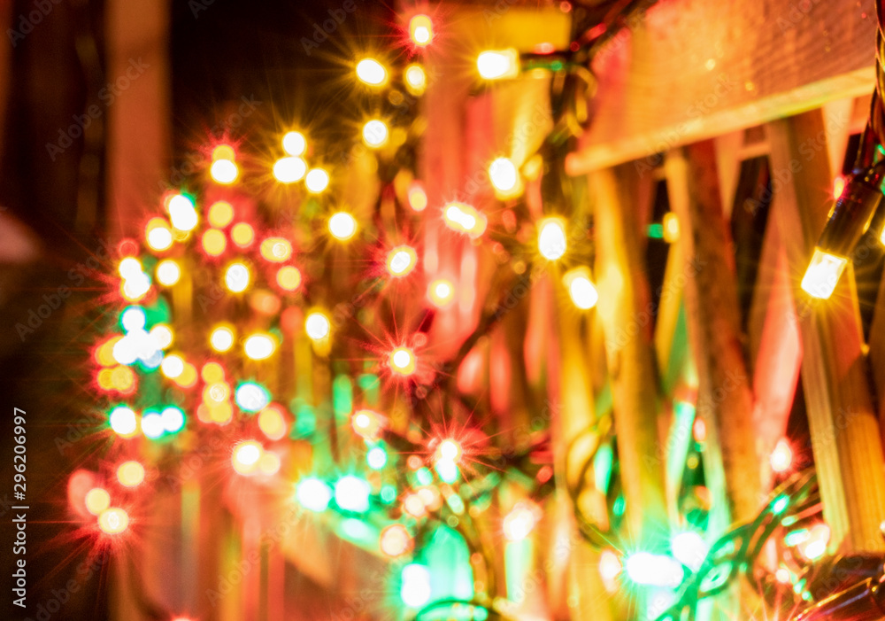 Very shiny Christmas decorations outside at night in Northern countries, Led lamps usage to save energy for green environment, blurred close up photo - lamps hung on wooden fence. Sweden Very shiny Christmas decorations outside at night in Northern countries, Led lamps usage to save energy for green environment, blurred close up photo - lamps hung on wooden fence. Sweden