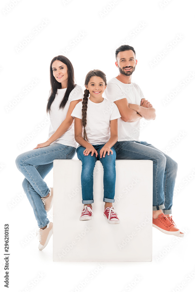 happy father with crossed arms sitting on cube near wife and kid isolated on white happy father with crossed arms sitting on cube near wife and kid isolated on white
