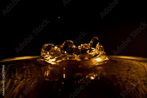 Water splash, golden water splash isolated on black background,water