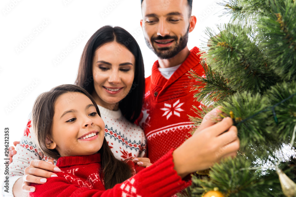 cheerful kid decorating christmas tree near parents isolated on white cheerful kid decorating christmas tree near parents isolated on white