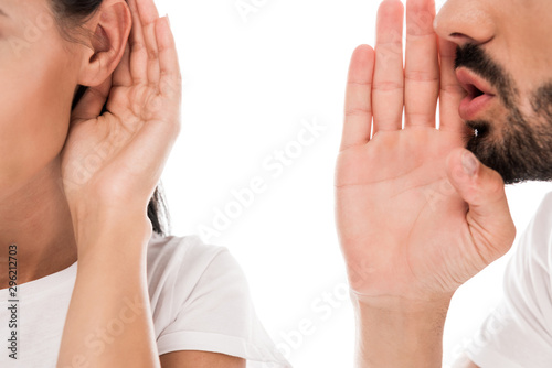 Obraz na plátně cropped view of bearded man gossiping near woman isolated on white