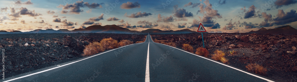 Image related to unexplored road journeys and adventures.Road through the scenic landscape to the destination in Lanzarote natural park