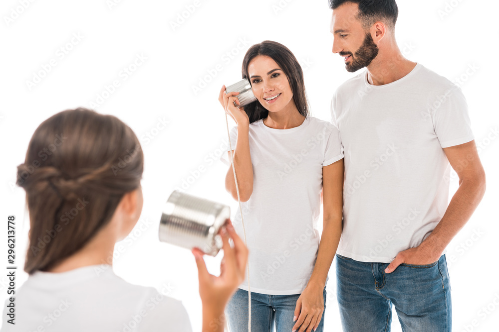 back view of kid holding tin can near happy parents isolated on while back view of kid holding tin can near happy parents isolated on while