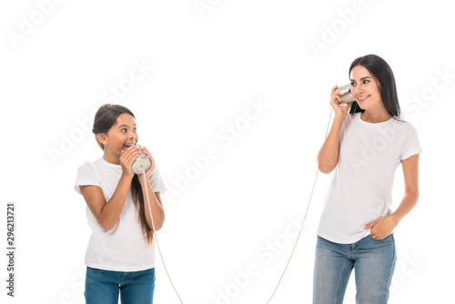 happy mother and daughter playing tin cans isolated on white