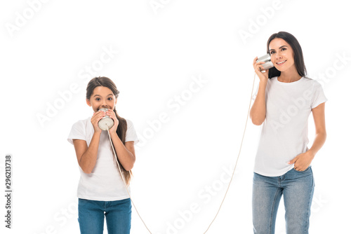 happy kid holding tin can and playing with attractive mother isolated on while