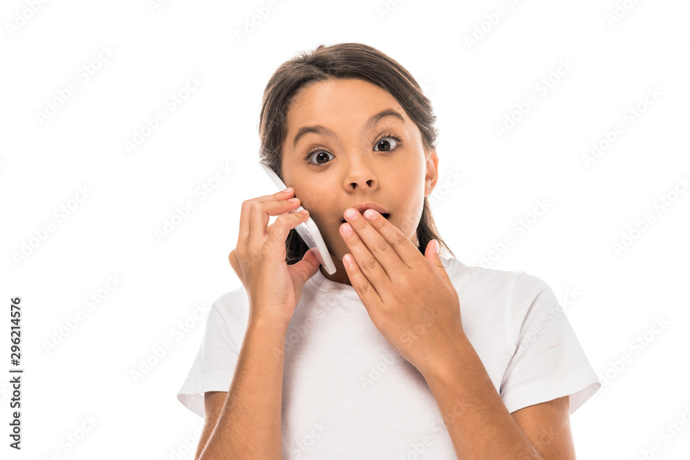 shocked kid talking on smartphone and covering mouth isolated on white shocked kid talking on smartphone and covering mouth isolated on white