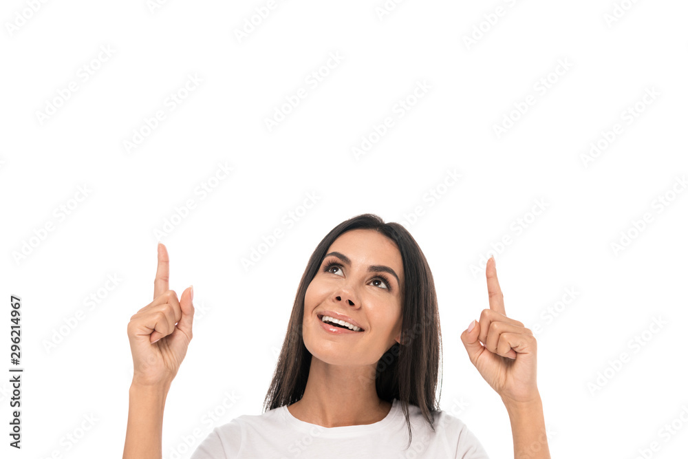 happy woman looking up and pointing with fingers isolated on white happy woman looking up and pointing with fingers isolated on white