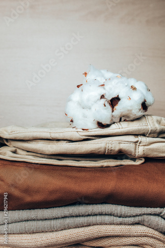  branch of cotton lies on a pile of clothes.