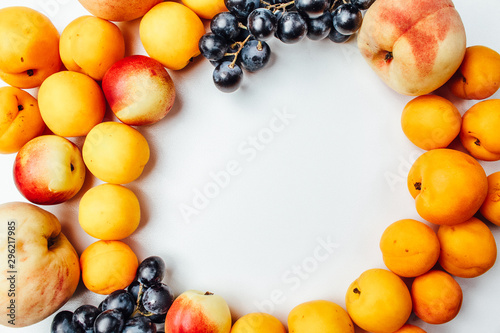 Fruit peaches  apricots and grapes on a white background