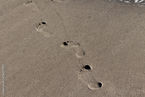 Footprints on the sea shore sand