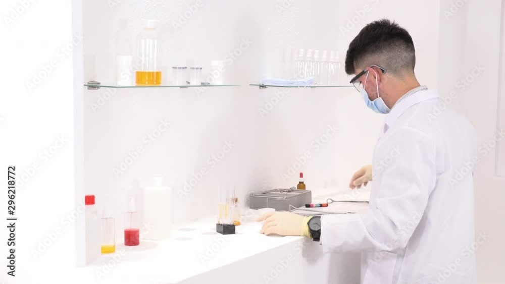Lab technician working in a laboratory and researching new medicines Lab technician working in a laboratory and researching new medicines