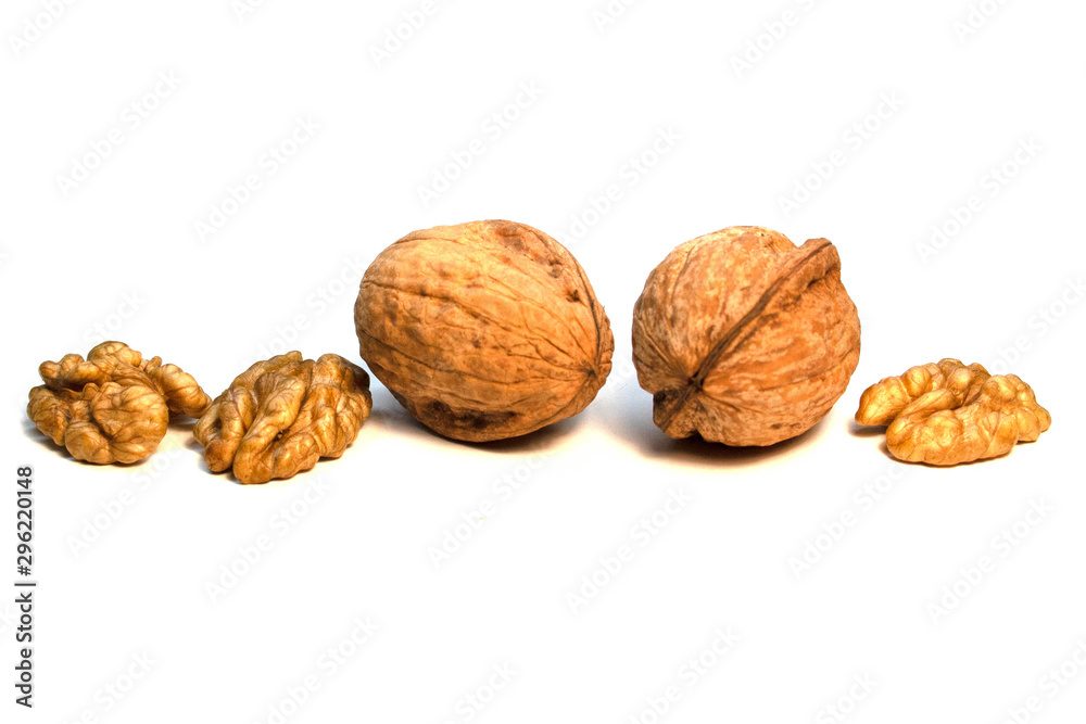 Walnuts in a shell and without it on a white background Walnuts in a shell and without it on a white background