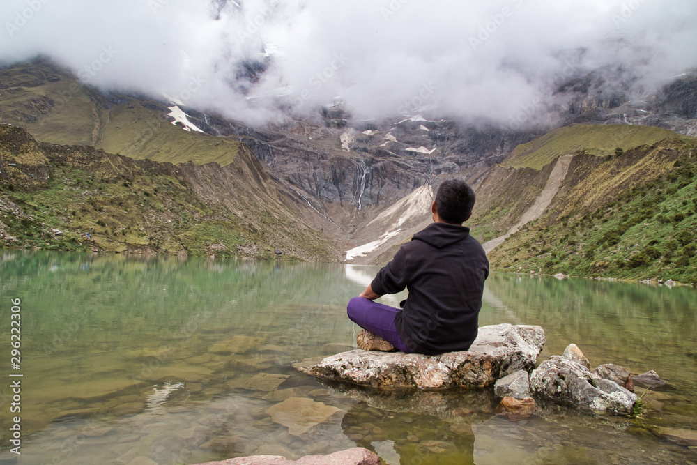 man in front of the Humantay Lake on the Salkantay Trail, the trek to Machu Picchu, Peru man in front of the Humantay Lake on the Salkantay Trail, the trek to Machu Picchu, Peru