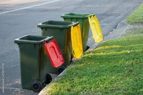 Obraz na plátně Australian garbage wheelie bins with colourful lids for recycling and general ho