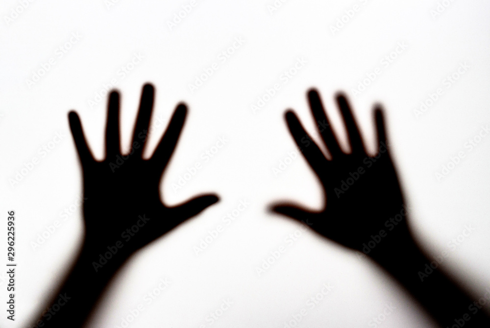 Dark silhouette of female hands on white background, concept of fear