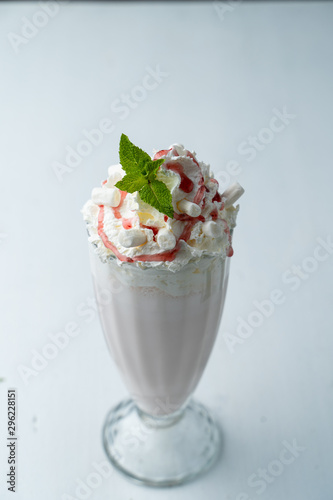 Classic vanilla milkshake with whipped cream isolated on white flat lay top view