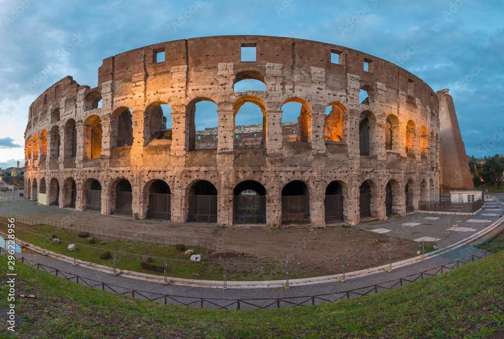panoramic of the backside of the Roman Colosseum illuminated at sunset