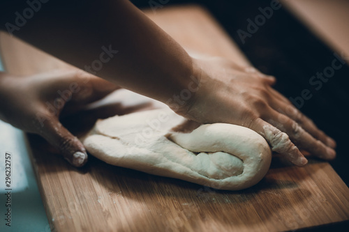 Woman prepare dumpling skin, Making dough on wooden table