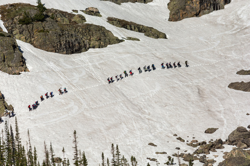 Snow Hikers walking through the Alpine tundra of the Rocky Mountain National Park © ericurquhart