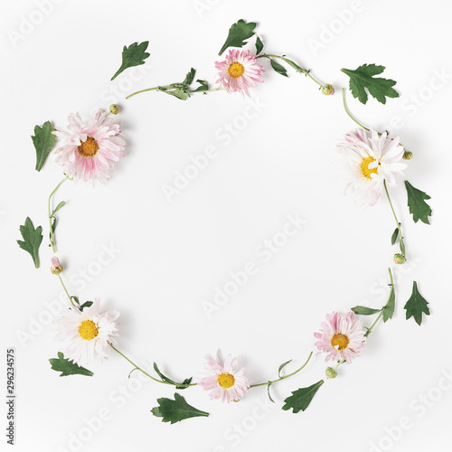 wreath made of flowers. beautiful composition pink chrysanthemums and green leaves on a white background.minimal concept  square frame  top view