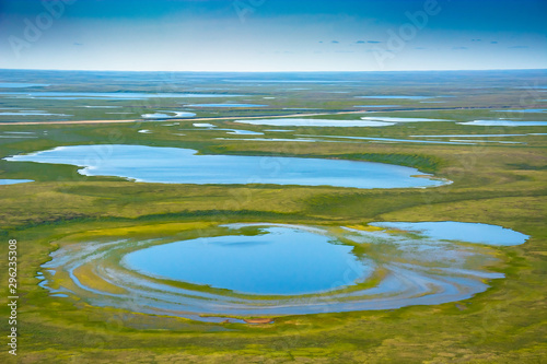 Landscape of the arctic tundra in summer. Rivers, lakes, northern vegetation. View from above. The concept of climate change, warming in the Arctic. photo