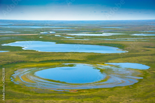Landscape of the arctic tundra in summer. Rivers, lakes, northern vegetation. View from above. The concept of climate change, warming in the Arctic.