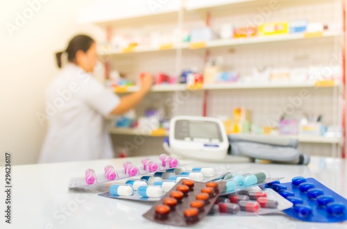 Pharmacist holding medicine pack in pharmacy drugstore